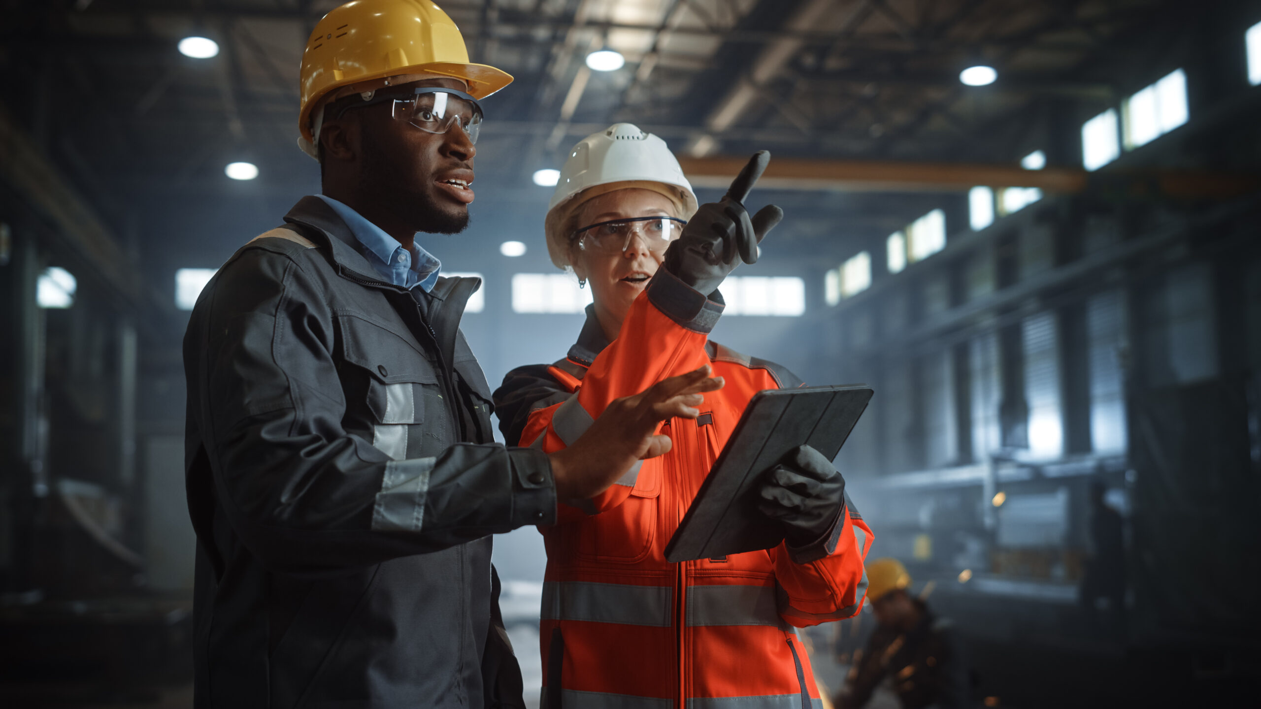 Two Heavy Industry Engineers Stand in Steel Metal Manufacturing Factory